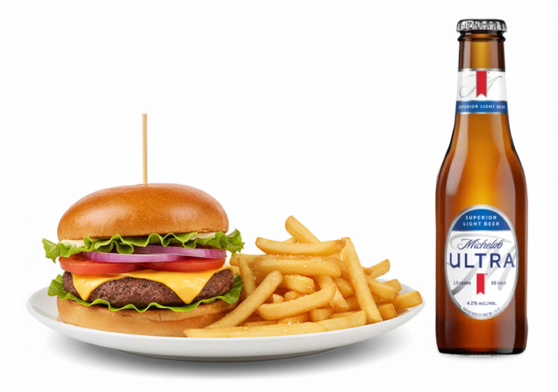 Burger and fries on a white plate next to a bottle of Michelob Ultra